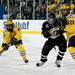 Michigan sophomore defenseman Mike Szuma (right) pushes off of Western Michigan senior center Ben Warda after a face-off on Saturday. Daniel Brenner I AnnArbor.com